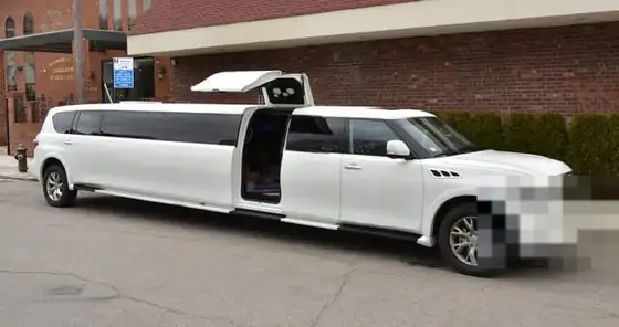 White Infiniti QX80 stretch SUV limousine
